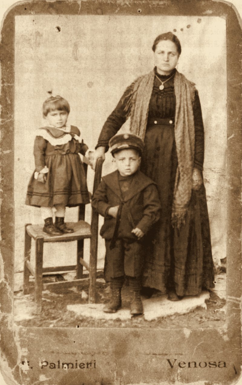 Sepia studio portrait of Maria Joanna La Centra standing with her two young children, Antonio and Elizabetta